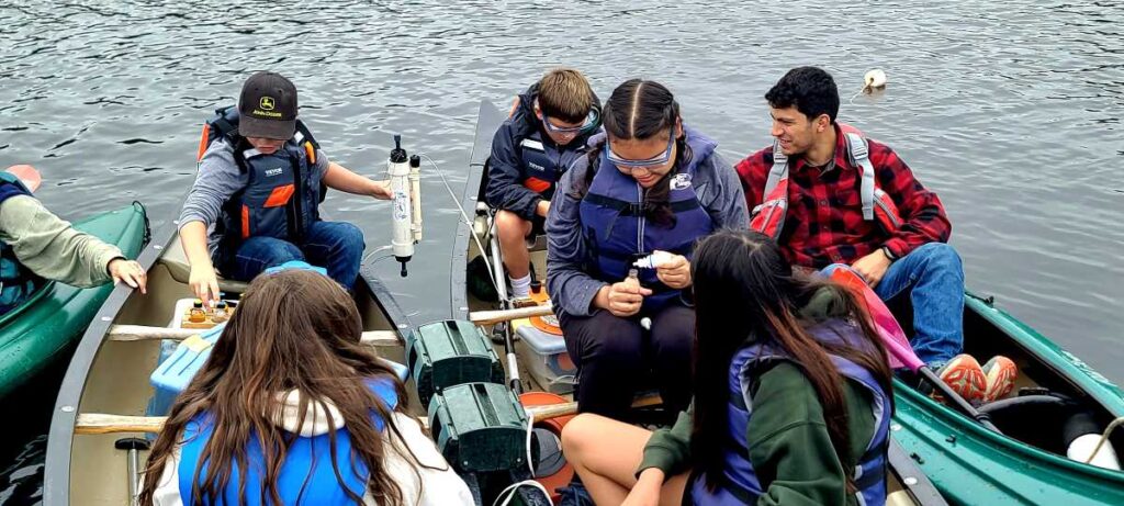 Stanley Grierson in kayak helping students with Floating Classroom sampling activities on Somes Pond, September 24th, 2025